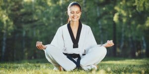 Martial Arts Lessons for Adults in Escondido CA - Happy Woman Meditated Sitting Background